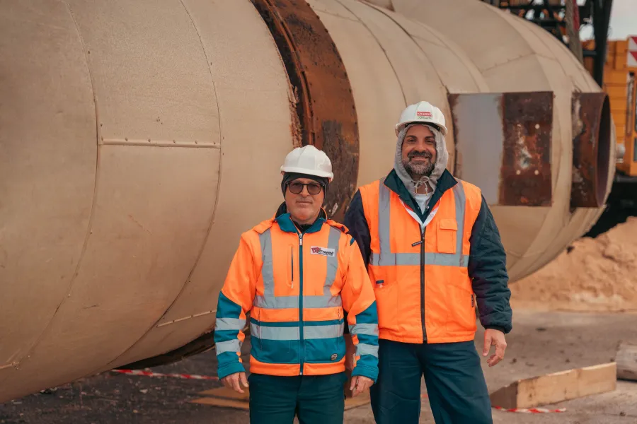Deux professionnels en casque et gilet haute visibilité sur un site industriel